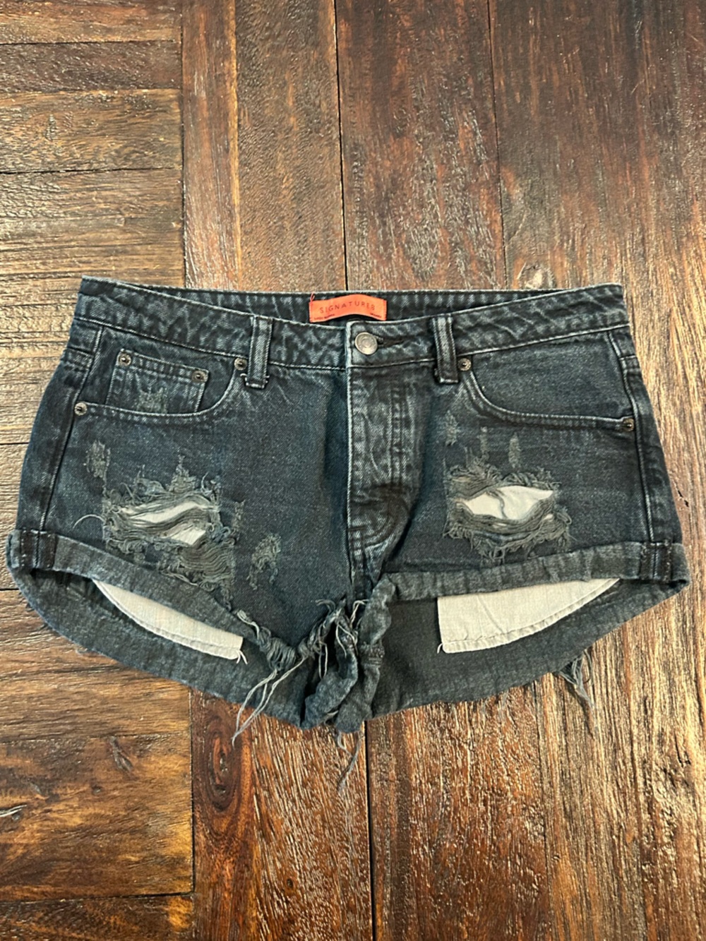 Distressed Black Denim Mid Rise Button Fly Mini Shorts with frayed hems